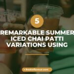 Summer iced chai patti served in a tall glass with rose petals and crushed ice on a wooden table wit