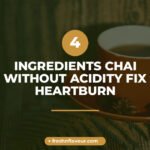 Golden chai without acidity in clear glass cup with whole lemongrass, green cardamom, spearmint leav
