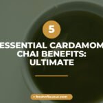 Golden cardamom chai in a glass cup with fresh green cardamom pods, mint and lemongrass highlighting