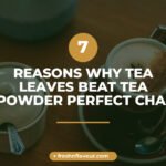 Premium tea leaves steeping in a cup of golden chai with whole spices like cardamom and ginger scatt
